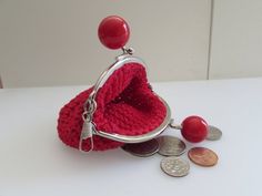 a small purse with some coins on the table