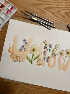 a watercolor painting with the word wild written in cursive letters and flowers