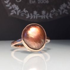 Rose Gold Pearl Ring. Natural Gold Pearl ring./Modern Pearl Ring/Unique Ring. Solitare Pearl Ring. Baroque Pearl Ring. Beautifully Handcrafted upcycled natural gold pearl set on a wider lightly hammered Rose goldfilled band.. This mixed metal modern unique yet very versatile ring is a size 9 1/2 but is available in any size with a very similar Pearl you can choose and is sure to be your go to accessory for all your fresh fall looks. Give the thoughtful gift of handcrafted❤️ Great bridesmaid gift Unique High Luster Round Jewelry, Unique Round High Luster Jewelry, Unique Round High-luster Jewelry, Handmade Elegant Copper Rings, High Luster Ring Jewelry Gift, High Luster Ring Jewelry For Gift, Unique Iridescent Moonstone Ring For Gift, Bohemian Handmade Iridescent Rings, Handmade Iridescent Rings For Wedding