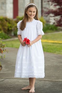 Capturing the charm of the south, the Virginia Lace Girls Dress is the perfect heirloom piece for a special occasion. This radiant dress is made with the finest lace and satin ribbon in a choice of white or ivory for an exquisite look. The mid-calf length and classic French seams define it as an exquisitely timeless piece to be cherished for years to come. Heirloom First Communion Dress, Vintage Flower Girls, Flower Girl Dresses Vintage, Vintage Dress Design, Girls Cotton Dresses, Heirloom Dresses, Vintage Girls Dresses, Girls White Dress, First Communion Dress