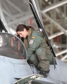 a woman in an air force jet looking out the window