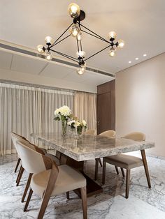 an elegant dining room with marble table and chairs