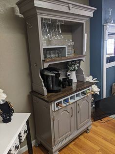 a gray hutch with wine glasses on it