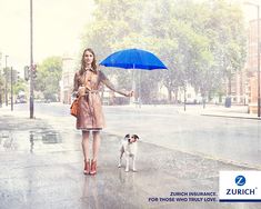 a woman holding an umbrella and walking her dog on a rainy day in the city