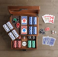 a wooden box filled with playing cards and dices