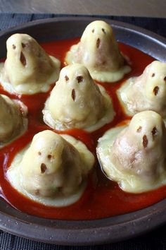 some dumplings are sitting in a red sauce