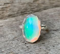 Dainty Oval White Aurora Opal Quartz Doublet Sterling Silver Ring | Multi Colored Opal Ring | October Birthstone | White Solitaire Ring by GildedBug on Etsy Minimalist Sterling Silver Opal Ring Oval, Minimalist Oval Opal Ring In Sterling Silver, Minimalist Sterling Silver Oval Opal Ring, Iridescent Oval Sterling Silver Jewelry, Oval Ethiopian Opal Moonstone Ring, Iridescent Oval Sterling Silver Rings, Dainty Handmade Oval Opal Ring, Iridescent Opal Ring In Sterling Silver For Anniversary, Silver Opal Ring With Oval Cabochon