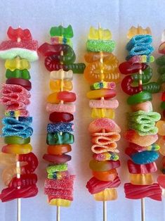 there are many colorful candy lollipops on the stick with candles in them