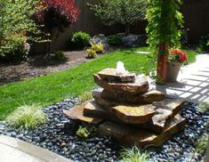 a stone fountain in the middle of a garden