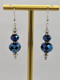 These are gorgeous handmade metallic blue dangle earrings.  ATTRIBUTES - Hooks for pierced ears - Artisan handmade - one of a kind - Glass beads are repurposed vintage  - Beads have a metallic coating - 925 Sterling silver hooks and head pins - Silvertone accents - Faceted beads have light wear from gentle use, findings are new MEASUREMENTS - 2.31" long x 0.51" wide CONDITION - Excellent GENTLY USED condition with minor wear MORE BEAUTIFUL EARRINGS - https://www.etsy.com/shop/SiftedandRefined?se Blue Metal Beaded Earrings For Gift, Silver Czech Glass Jewelry With Matching Earrings, Metal Beaded Earrings With Faceted Beads For Gifts, Adjustable Metal Earrings With Faceted Beads, Blue Round Bead Crystal Earrings For Gifts, Adjustable Czech Glass Earrings With Faceted Beads, Nickel-free Blue Round Bead Jewelry, Blue Crystal Round Bead Earrings For Gift, Blue Round Beads Crystal Earrings For Gift