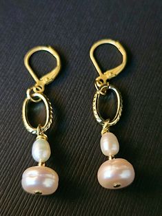 Make a statement with these stunning White Baroque Pearl drop earrings! Featuring textured oval chain links and classic lever back ear wires, these earrings are both elegant and unique. The button cap pearls measure 9.20mm x 6.0mm and are accented with small oval freshwater pearls and gold beads for added sophistication. With a 1 3/4 drop in length, these earrings beautifully showcase the pearls' nice luster and glow. Perfect for adding a touch of timeless glamour to any outfit. Elegant Handmade Oval Pearl Earrings, Elegant Nickel-free Oval Link Jewelry, Elegant Nickel-free Jewelry, Elegant Oval Jewelry With French Hook, Classic Handmade Oval Link Jewelry, Elegant Pink Oval Link Jewelry, Gold Bead Earrings, Timeless Glamour, Chain Links