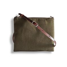 Our simple crossbody bag has a slim profile, an adjustable leather strap and a zippered closure.  This textured linen bag is lightweight, easy to carry and comes in a neutral, forest-green color with a brown leather strap.  Two interior slip pockets keep your items organized and secure.  All handmade with attention to detail and durability.   Perfect bag for travel, vacation, or everyday errands. Details: Size is 9.5 in L x 8.5 in H   (24.13cm x 21.59cm)\ Exterior is natural textured linen Inter Be Organized, Small Buckets, Bag For Travel, Bucket Bags, Brown Leather Strap, Linen Bag, Perfect Bag, Baby Bag, Travel Vacation