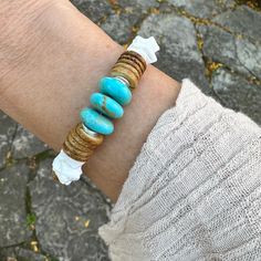 "This unique one-of-a-kind bracelet is made with 10mm pure white artisan grade seashells from the North Atlantic, blue Arizona disk bead turquoise and brown coconut shell. The irregular disc cut of the shell is organic, wavy and asymmetrical. The beads are tumbled to smooth the edges and give the beads a fine satin finish. The round irregular turquoise disk beads are mined in Arizona. The tan colored coconut shells are from Hawaii USA and hardened to a jewelry grade gem.  The appearance of the f White Hand Wrapped Bracelet, Unique Hand Wrapped White Bracelet, White Bohemian Jewelry With Oyster Bracelet, Adjustable Oyster Bracelet With Ocean-inspired Style, White Gemstone Beads Bracelets For Beach, Adjustable Ocean-inspired Oyster Bracelet, White Bohemian Stretch Bracelet Hand Wrapped, Bohemian White Stretch Bracelet Hand Wrapped, White Bohemian Hand Wrapped Stretch Bracelet