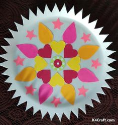 a paper plate that has been made to look like a flower with stars on it