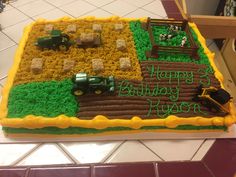 a birthday cake that is shaped like a farm scene with tractor and hay on it