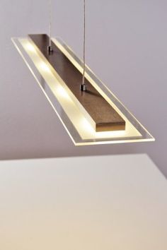 a suspended light fixture in the shape of a rectangle with two lights on each side