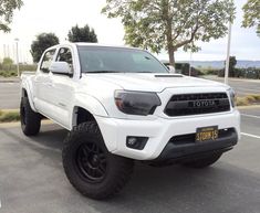 a white toyota truck parked in a parking lot