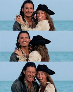 two people are smiling and hugging each other on the beach, one is wearing a pirate hat