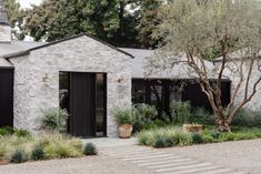 a stone house with black doors and windows