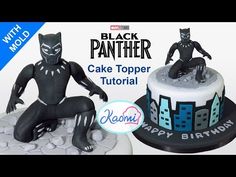 a black panther cake topper sitting next to a birthday cake