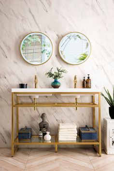 two mirrors on the wall above a console table