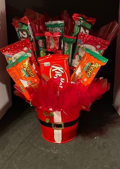 a red bucket filled with candy and candies