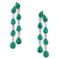 Tresor Diamond Earring features 0.79 cts diamond and 10.36 cts emerald in 18k white gold. The Earring are an ode to the luxurious yet classic beauty with sparkly diamonds. Their contemporary and modern design makes them versatile in their use. The earrings are perfect to be worn daily, at parties, music galas, charity events, conferences, and even weddings. Luxury Green Chandelier Earrings For Festive Occasions, Luxury Green Diamond Hoop Earrings, Luxury Green Brilliant Cut Earrings, Luxury Green Halo Design Earrings, Long Drop Earrings Diamonds, Diamond Chandelier Earrings, Modern Gold Jewelry, Bracelets Design, Charity Events