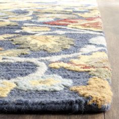 an area rug with various colored flowers on it