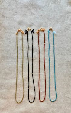 Great for everyday wear! Very tiny and delicate. Muted neutral tones. This tiny necklace is made with high quality Japanese seed beads that are perfect cylinders. Necklace clasp and jump rings are gold plated. Natural silk cord with frayed tassel ends. Available in 4 matte colors: burnt umber, palm, black, and ocean. 📏Not sure which length to choose? Add a chain extender: https://etsy.me/34lPf3m ✨ FREE SHIPPING IN THE USA ✨ 🌎 Packaging 🌎 To be environmentally responsible about packaging we wi Adjustable Gold Beaded Everyday Necklaces, Adjustable Gold Beaded Necklaces For Everyday, Handmade Delicate Beaded Necklaces For Everyday, Delicate Handmade Beaded Necklaces, Adjustable Minimalist Beaded Necklaces With Colorful Beads, Minimalist Adjustable Beaded Necklace With Gold Beads, Minimalist Colorful Adjustable Beaded Necklaces, Minimalist Adjustable Colorful Beaded Necklaces, Everyday Bohemian Beaded Necklaces With Tiny Beads