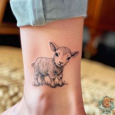 a small sheep tattoo on the ankle