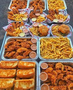 several trays filled with different types of fried food on top of eachother