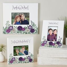 two white frames with purple flowers and the word mommy on them are sitting next to a potted plant