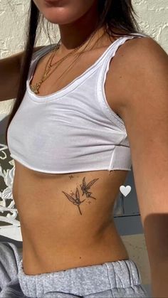 a woman with a small tattoo on her stomach