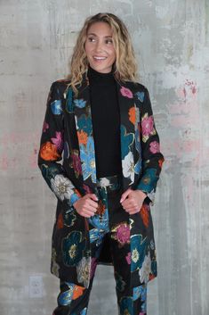 Elevate your wardrobe with this stunning long black blazer, featuring a bold multicolor mod floral and gold print that seamlessly blends classic elegance with contemporary flair. The tailored silhouette offers a flattering fit, perfect for layering over your favorite outfits, while the vibrant floral design adds a pop of color and personality. Crafted from premium fabric with attention to every detail, this blazer embodies both sophistication and fun, making it a standout piece for any occasion. Chic Fitted Blazer With Floral Print, Chic Notch Lapel Outerwear With Floral Print, Elegant Black Blazer With Floral Print, Elegant Black Floral Print Blazer, Chic Outerwear With Floral Print And Notch Lapel, Floral Print Long Sleeve Blazer For Party, Long Sleeve Floral Print Blazer For Party, Chic Floral Print Outerwear With Notch Lapel, Formal Fall Floral Print Blazer