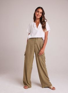 Introducing our Cargo Wide Leg Pant, the perfect addition to your summer wardrobe. This relaxed fit trouser is designed to provide both comfort and style, allowing you to effortlessly elevate your look. 100% TENCEL ™ Lyocell. SIZE WAIST WAIST TO HEM INSEAM XS 25" 42 1/4" 31" S 27" 42 3/4" 31" M 29" 43 1/4" 31" L 31" 43 3/4" 31" Casual Olive Wide Leg Pants With Pockets, Chic Olive Summer Pants, Olive Pants For Summer Workwear, Casual Olive Wide-leg Pants, Summer Workwear Olive Bottoms, Olive Bottoms For Summer Workwear, Summer Olive Workwear Bottoms, Olive Wide Leg Cargo Pants For Work, Casual Olive Bottoms For Work