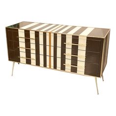 a brown and white striped dresser with metal legs