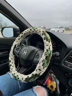 the steering wheel cover is crocheted with yarn