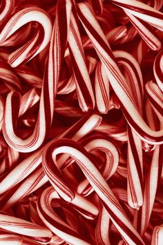 a pile of red and white spirals on top of each other in the shape of letters