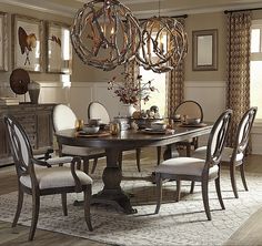 a dining room table with chairs and a chandelier