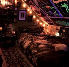 a bed with lots of lights on it in a room filled with pictures and decorations