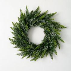 a close up of a wreath on a white wall