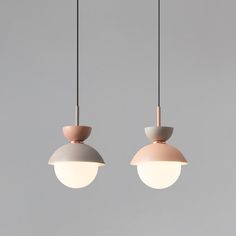 two pendant lights hanging from the ceiling with one light turned on and another being off