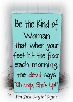 a blue sign with the words be the kind of woman that when your feet hit the floor each morning, the devil says