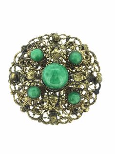 An antique costume green Czech Glass Brooch Pin unknown Metal filigree in excellent Condition throughout measuring 4cm x 4cm All pieces are unique I aim to provide you with a 5 star service and customer satisfaction is my priority. You can purchase with confidence we are here to assist you. All my items are vintage and pre owned so at times they will have signs of age but I try my very best to describe them with accuracy. Your purchase will be carefully packed to protect it. If you wish it wrapped as a gift for someone then do let me know please. SHIPPING U.K.POSTAGE: FREE SHIPPING  Royal Mail Special delivery INTERNATIONAL SHIPPING  FREE SHIPPING WORLDWIDE  ROYAL MAIL I SHIP TRACKED SIGNED AND INSURED BUT IT DOES NOT COVER CUSTOM CHARGES IN YOUR COUNTRY. Collectible Art Nouveau Filigree Brooches, Art Nouveau Filigree Brooch For Collectors, Green Round Brooches For Wedding, Green Round Wedding Brooches, Victorian Green Collectible Brooches, Vintage Green Brooch Jewelry, Vintage Green Brooch For Formal Occasion, Green Vintage Brooch For Formal Occasions, Green Round Brooch For Formal Occasions