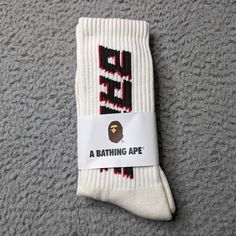 A Bathing Ape Crew Socks Logo Mens Womens Unisex Size: One Size Fits All Color: Cream White Black Red Brand New In Packaging. Fast Shipping! 1 Day Shipping And Handling. Breathable Streetwear Socks, Comfortable Breathable Socks For Streetwear, Comfortable Breathable Streetwear Socks, Sporty Cotton Socks With Letter Print, Sporty Winter Socks For Streetwear, Sports Cotton Socks With Letter Print, Cotton Socks With Letter Print For Streetwear, Trendy White Socks For Streetwear, Trendy White Streetwear Socks