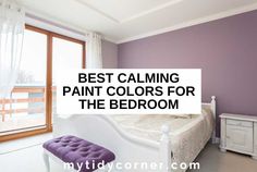 a bedroom with purple walls, white furniture and a large window that says best calming paint colors for the bedroom