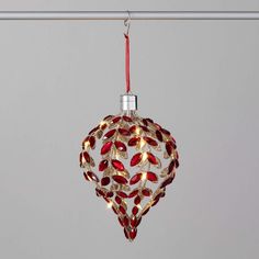 A festive accent for your holiday decor, this ornate teardrop ornament brings subtly lit radiance. Crafted from gold-toned metal with lustrous red and gold glitter details, the ornament's design feels both timeless and modern. The lighted option reveals its warm, soothing warm glow, perfect for a night light or as an eye-catching addition to your Christmas tree. Simply insert 3 Cr2032 batteries (not included), activate and enjoy the lustrous light emanating from this exquisite bespoke ornament. Red Gold Ornaments Christmas Tree, Red Tree Ornaments, Indoor Holiday Decor, Frosted Tree, Unique Ornaments, Cabin Christmas, Christmas Glitter, Holiday Store, Red Gemstones