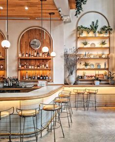 an empty bar with lots of chairs and shelves