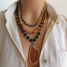 Meet our Extraordinarily Unique Agate and Onyx Necklace, a stunning multi-strand, handmade piece of jewelry. This statement necklace is the perfect accessory for women who like to draw attention with their jewelry. It makes a thoughtful birthday gift for that special person in your life. MATERIALS: This stunning necklace is meticulously crafted from high quality agate and onyx stones and carefully combined to create a beautiful multi-strand design. The combination of these natural stones creates Bold Statement Necklaces, Ceramic Necklace, Onyx Necklace, Mineral Stone, Onyx Bead, Onyx Stone, Stunning Necklace, Birthday Gifts For Women, Special Person