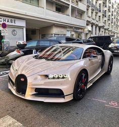 a white bugatti is parked on the street